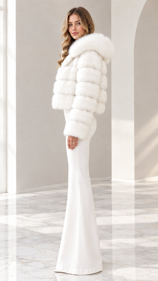 Side angle view of model wearing white hooded cropped faux fur jacket