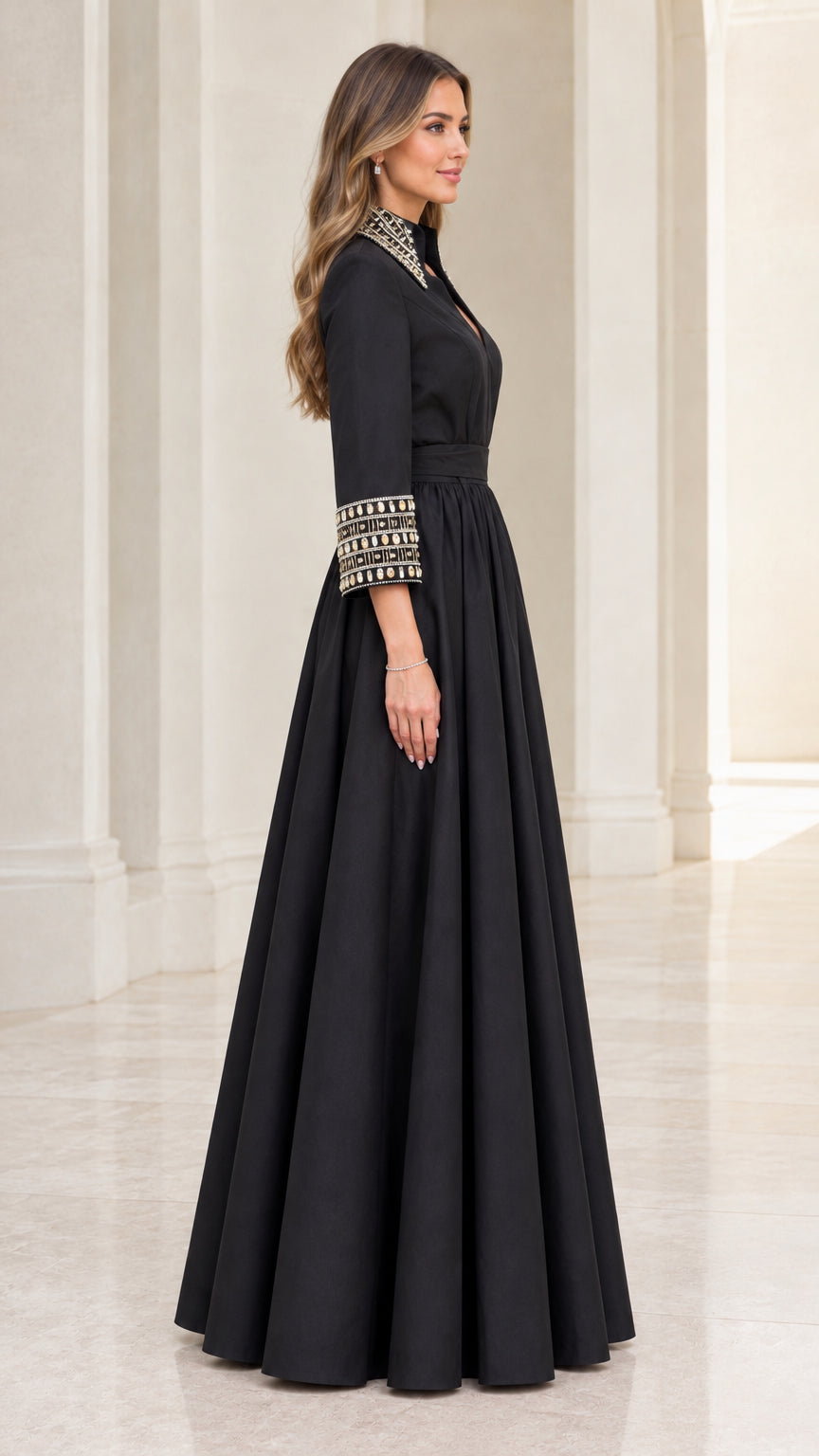 Side profile view of black formal maxi dress with beaded cuffs and full skirt