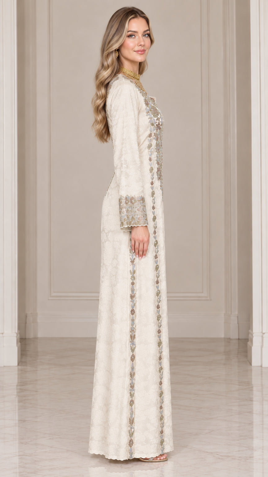 Side profile view of ivory embroidered maxi dress showing long sleeve and straight silhouette