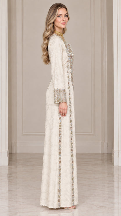 Side profile view of ivory embroidered maxi dress showing long sleeve and straight silhouette