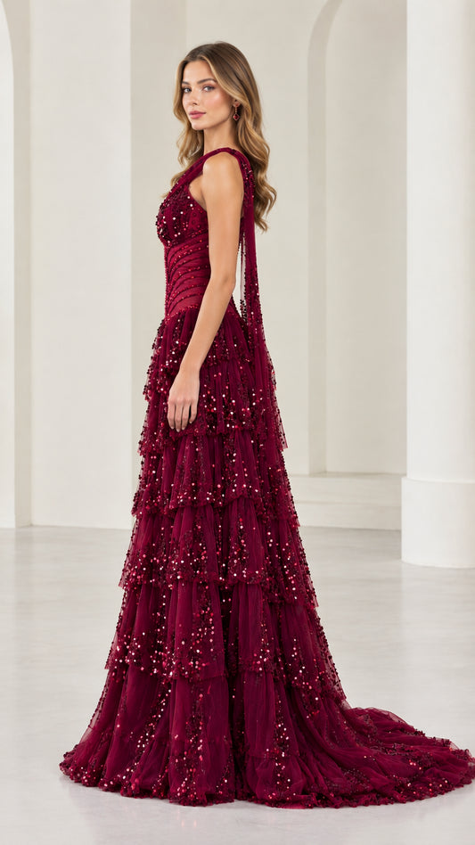 Side profile of burgundy tiered sequin evening dress with train