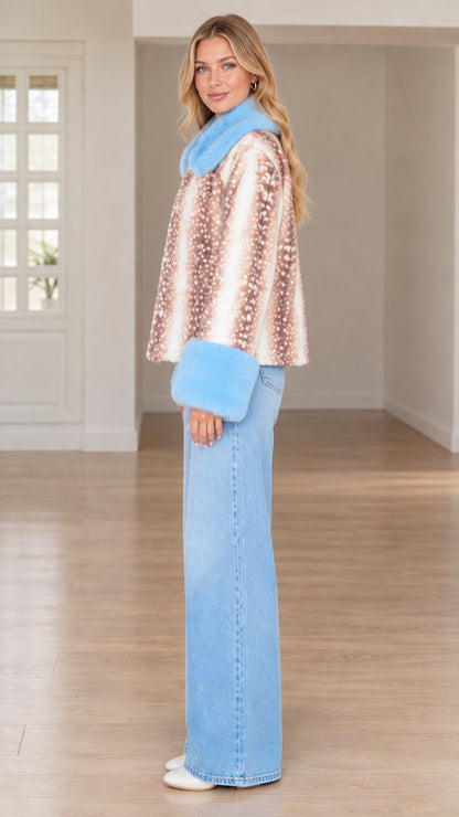 Side profile of model wearing brown deer print faux fur jacket and light wash jeans