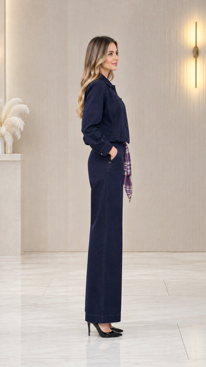 Side profile view of women's navy blue two-piece jacket and wide-leg pants set