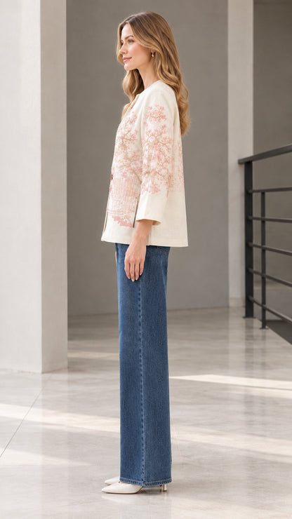 Side profile view of model wearing cream embroidered jacket