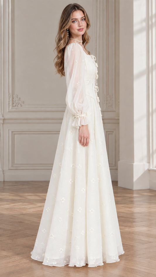 Side profile view of ivory embroidered tie-front maxi gown