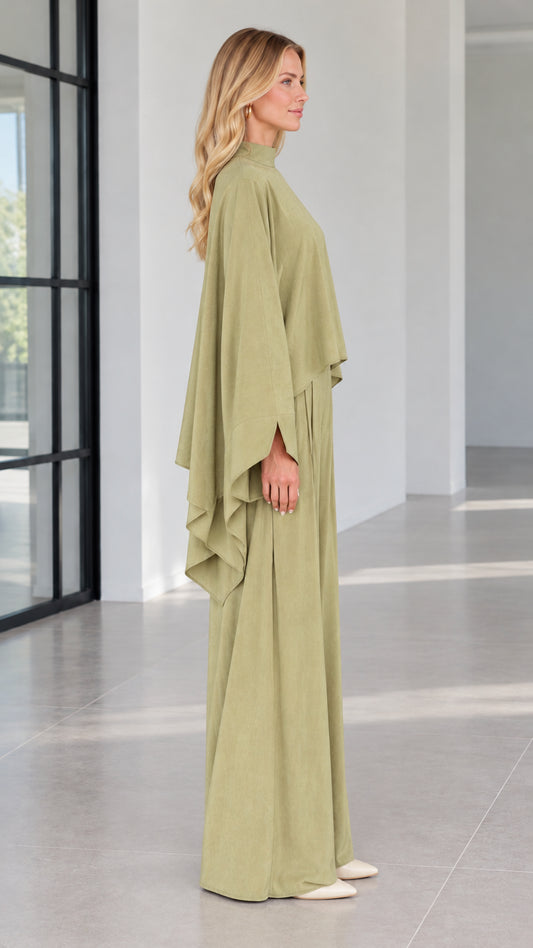 Side profile view of woman modeling sage green draped cape sleeve pant set