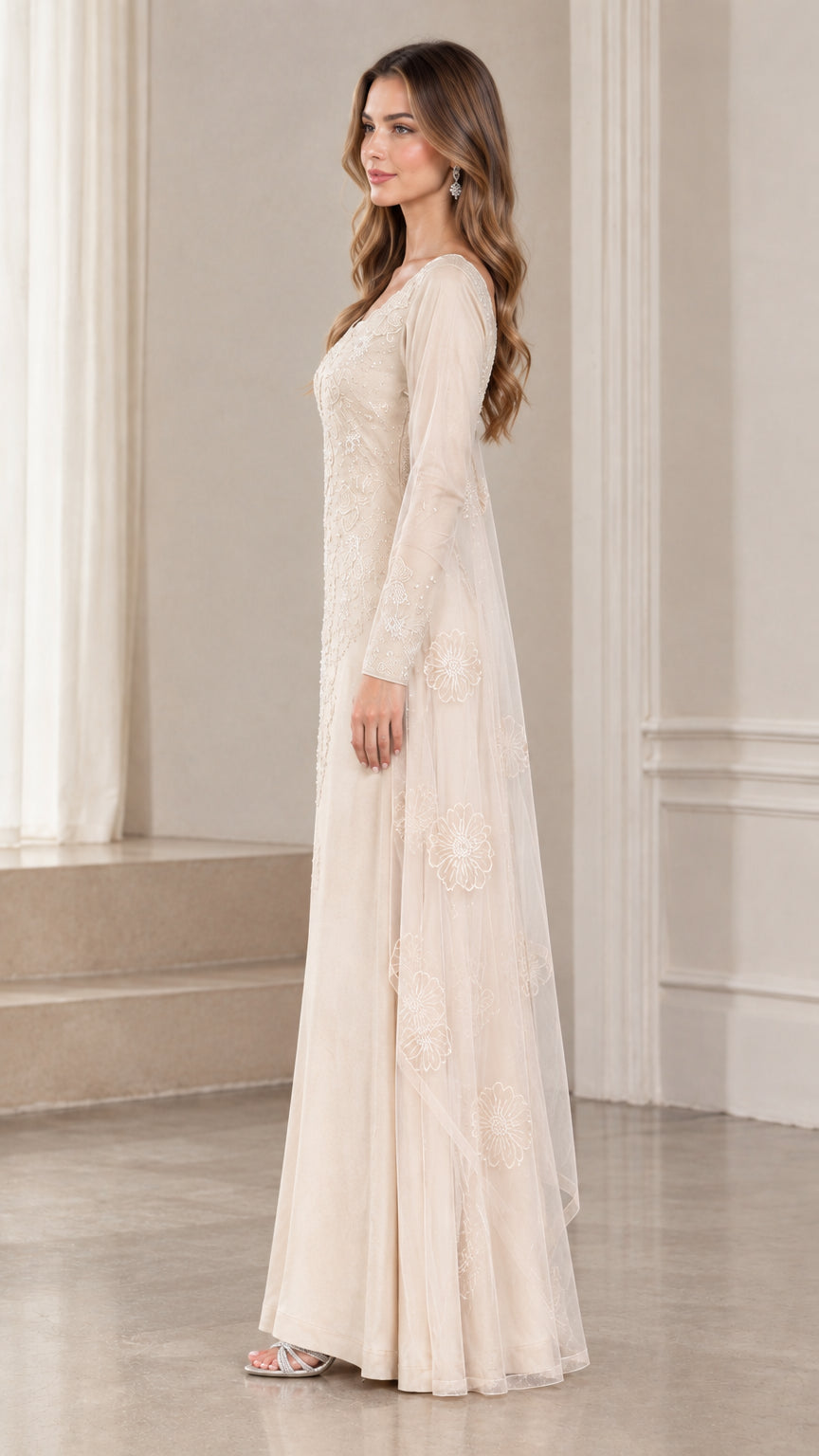 Side profile view of champagne embroidered long sleeve maxi gown