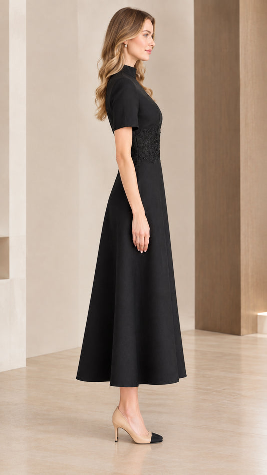 Side profile of woman wearing black short sleeve fit and flare midi dress
