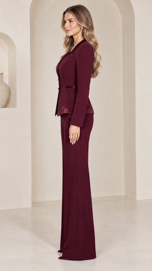 Side profile view of burgundy tailored two-piece pant suit