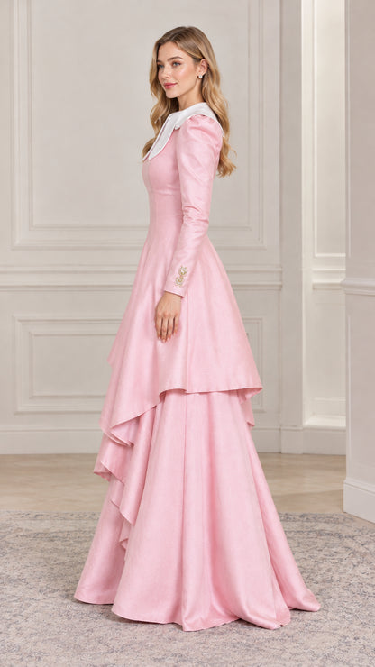 Side profile view of woman modeling pink tiered A-line formal dress
