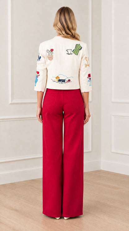 Back view of cream cropped jacket highlighting embroidered landscape and teapot details