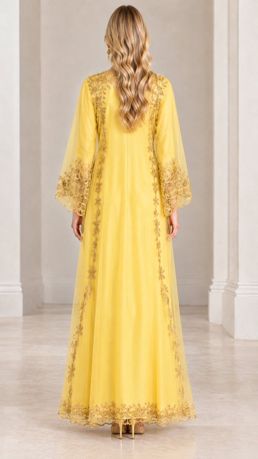 Back view of woman wearing yellow long-sleeve embroidered kaftan dress