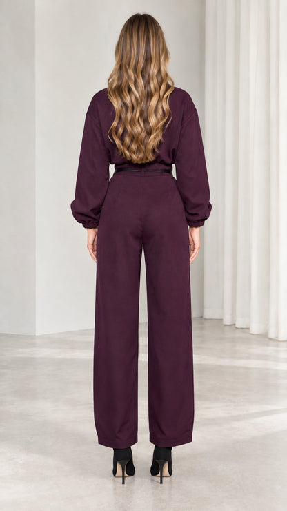 Back view of model in burgundy long sleeve utility jumpsuit