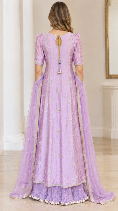 Back view of lavender gown highlighting keyhole back detail and tassel accents