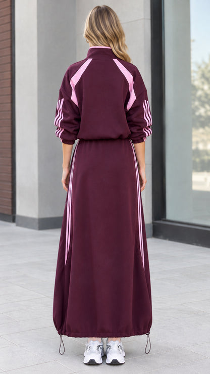 Back view of woman wearing burgundy track jacket and matching maxi skirt set