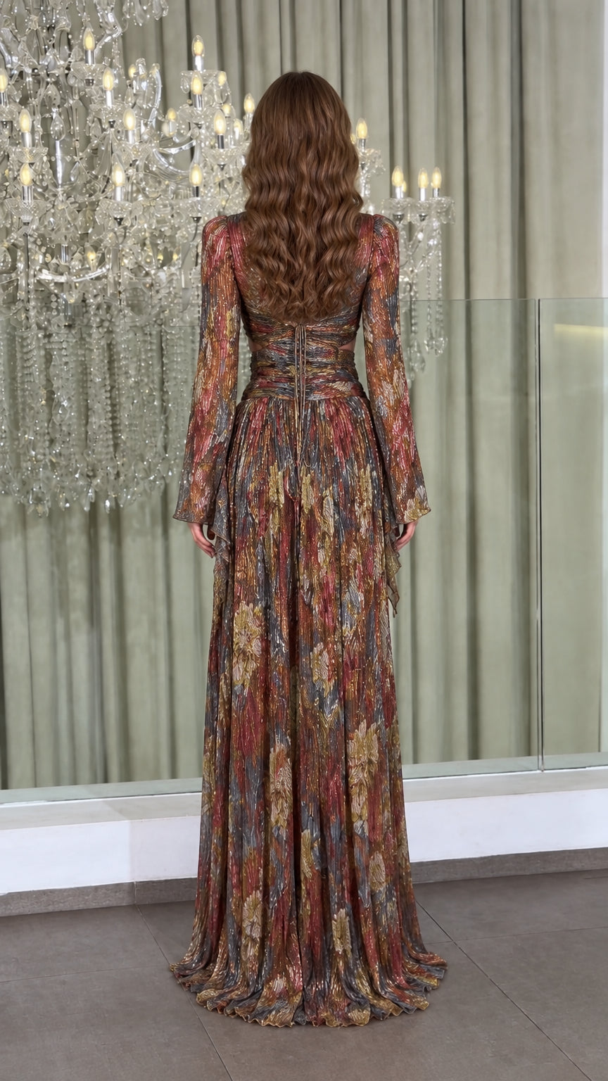 Back view of model wearing metallic plissé gown showcasing crisscross lace-up back