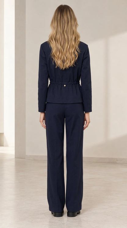Back view of model wearing Navy Blue drawstring waist jacket and trousers