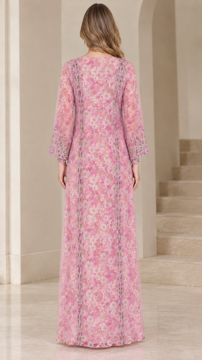 Back view of woman wearing floor-length pink floral kaftan dress