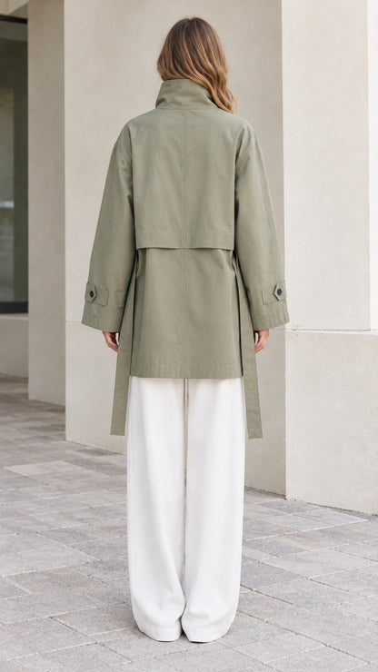 Back view of Sage Green high-neck jacket showcasing rear storm flap and waist belt