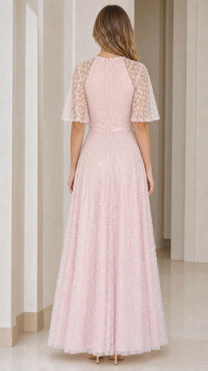Back view of woman wearing blush pink flutter sleeve formal gown