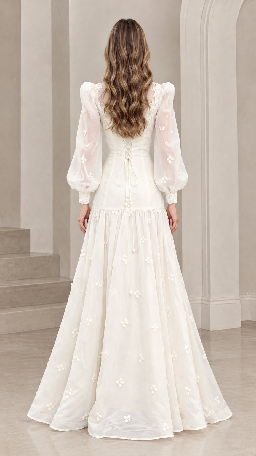 Back full-length view of woman in ivory Victorian-inspired maxi gown