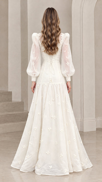 Back full-length view of woman in ivory Victorian-inspired maxi gown