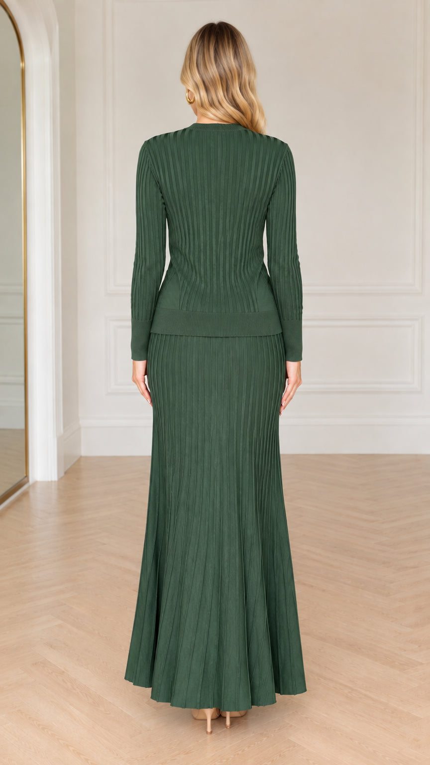 Back view of model in forest green long sleeve ribbed knit cardigan and maxi skirt