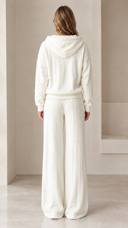 Back view of woman wearing white cable knit hoodie and wide leg pants set