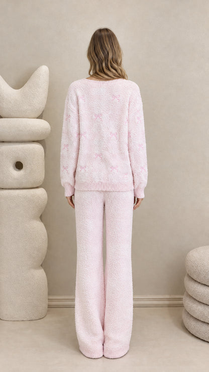Back view of model wearing pink plush knit cardigan and wide-leg lounge pants