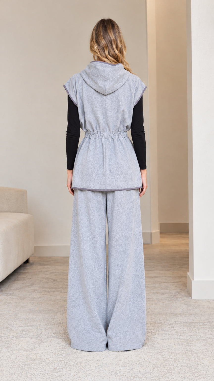Back view of model wearing heather grey hooded loungewear set with wide legs