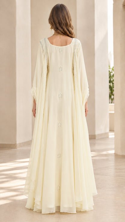 Back view of ivory floor-length evening gown with draped cape effect