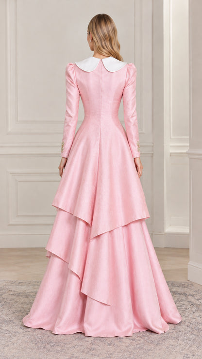 Back full-length view of woman showing cascading layered skirt on pink formal dress
