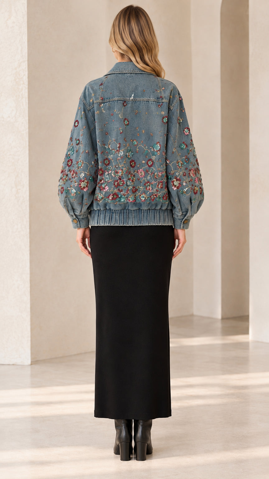 Back view of model wearing Denim Blue floral embroidered denim jacket