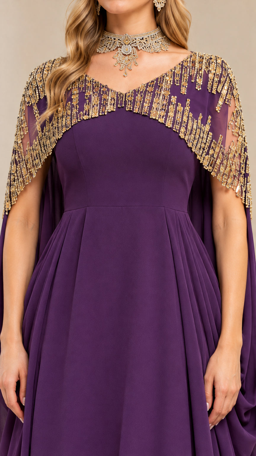 Close-up detail of the metallic beaded cape neckline and bodice