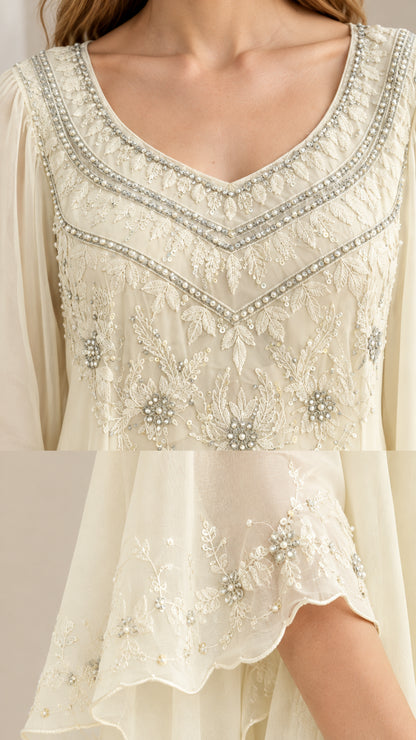 Detailed close-up of beaded embroidery on the neckline and sleeve cuff
