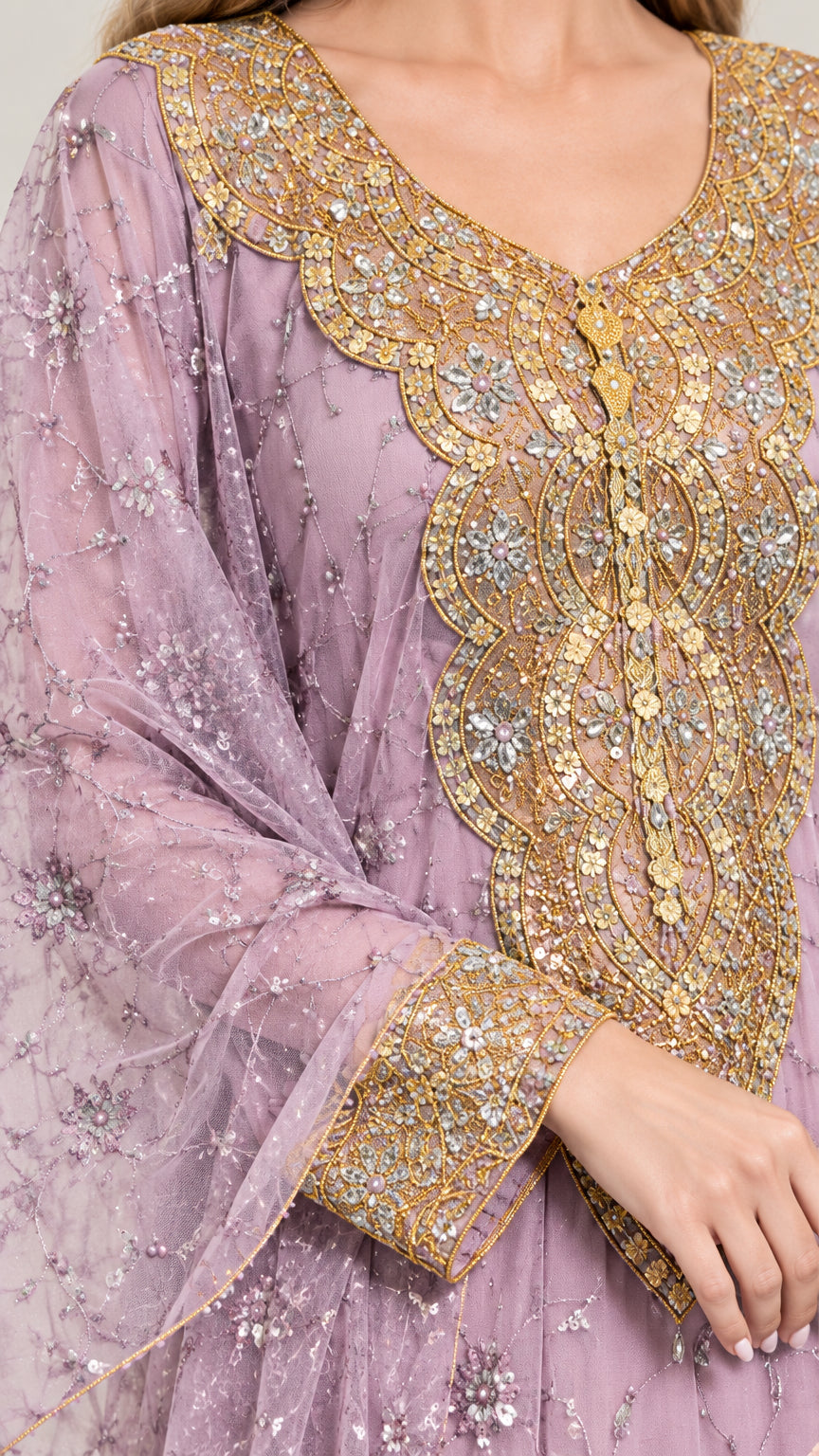 Close-up of intricate metallic gold embroidery and beading on lavender neckline and cuffs
