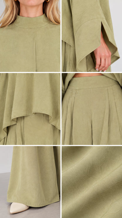 Close-up details of neckline, split sleeve, hemline, waistband, and smooth fabric texture