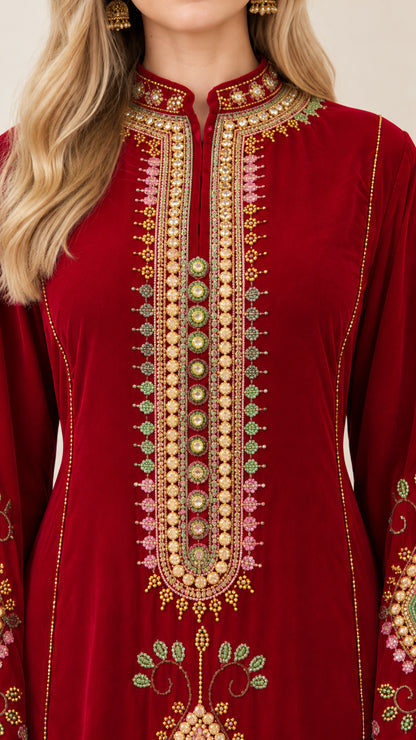 Close-up detail of ornate gold and pastel embroidery on neckline and chest