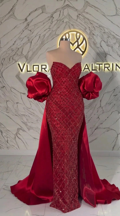 Mannequin display of Ruby Red sequin sweetheart gown with satin cape train