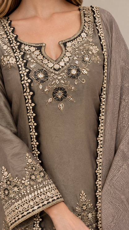 Close-up of intricate metallic floral neckline embroidery and sheer dupatta