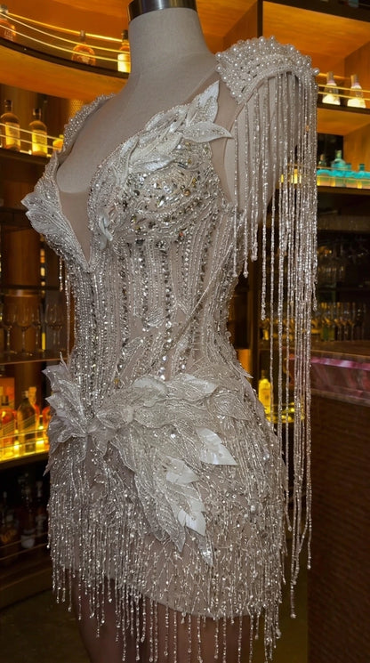 Close-up detail of Champagne corset mini dress showcasing beadwork and leaf appliques on mannequin