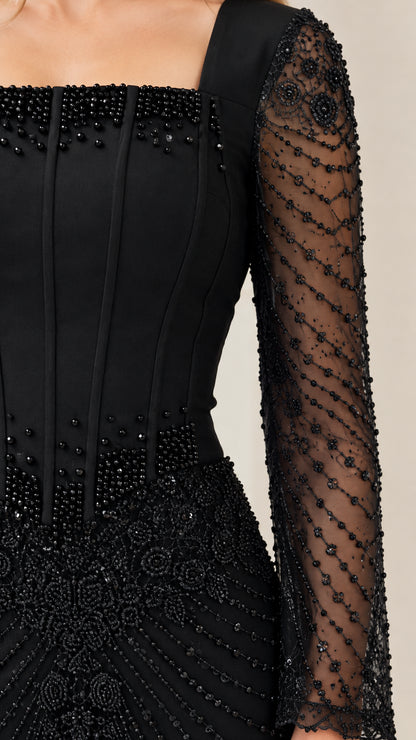 Close-up detail of black corset bodice and beaded mesh long sleeve