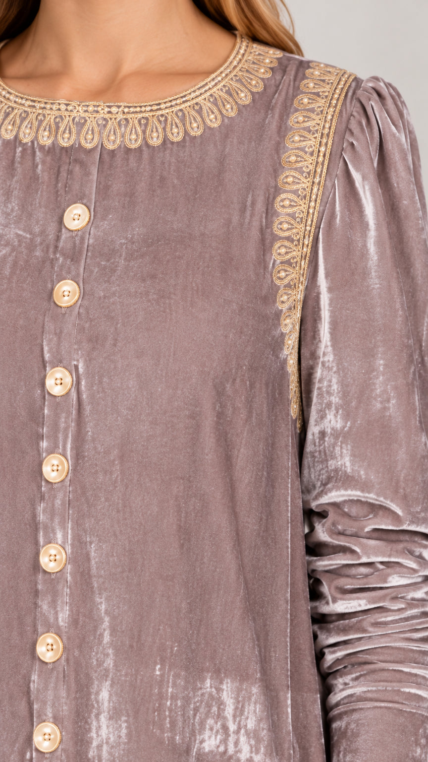 Close up of gold embroidery along the round neckline and button placket