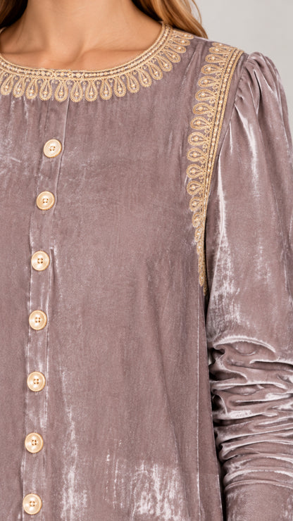 Close up of gold embroidery along the round neckline and button placket