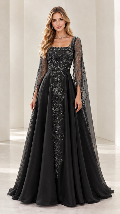 Woman wearing black embroidered beaded A-line evening gown with cape sleeves