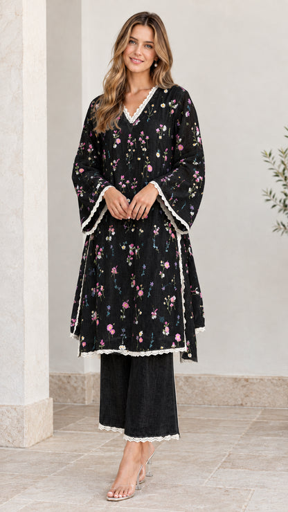 Full-length view of woman wearing black floral embroidered tunic and pant set
