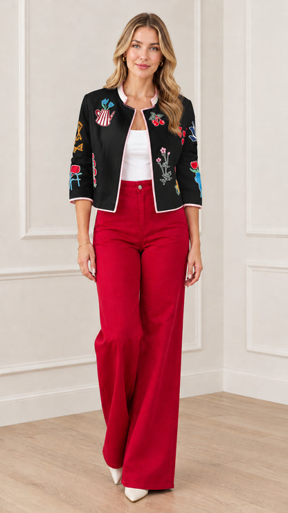Black embroidered open front cropped jacket styled with red trousers