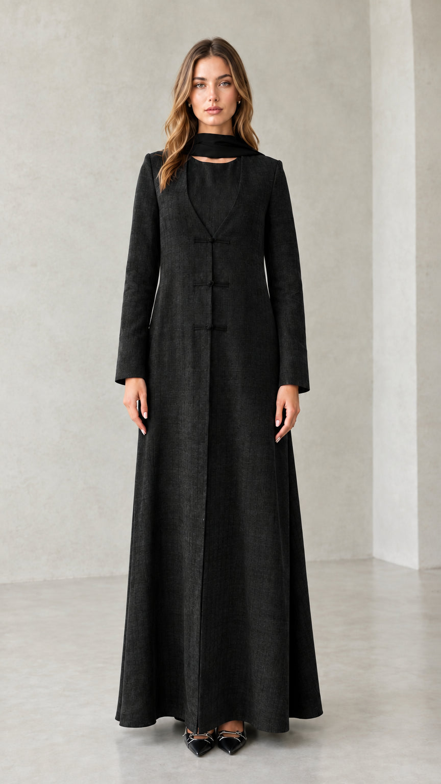 Front view of model wearing Black textured long sleeve maxi coat dress