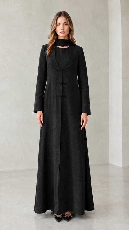 Front view of model wearing Black textured long sleeve maxi coat dress