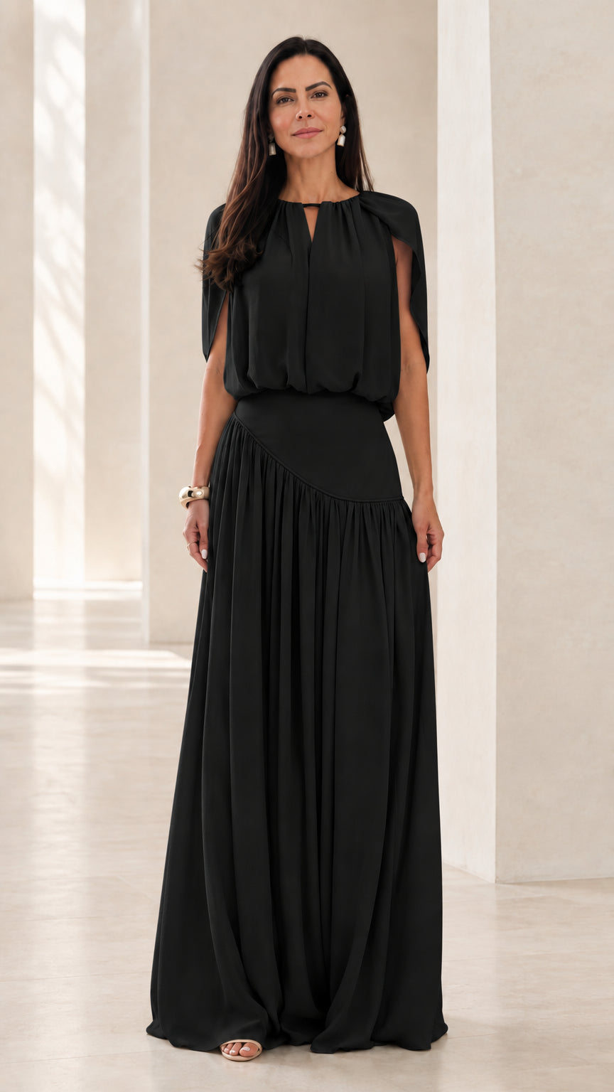 Front view of model wearing Black cape sleeve asymmetrical maxi dress